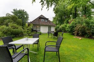 a group of chairs and a table in a yard at Appartement Skagen in Glücksburg
