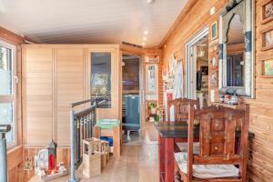 a dining room with a table and wooden walls at Eifelyeti Ferienwohnung mit Sauna in Ellscheid