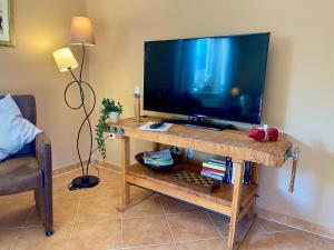 a large flat screen tv on a wooden table at Ferienwohnung an der Schlei in Fleckeby