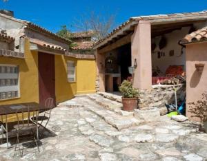 a house with a stone patio in front of it at Casa Jara in Azuara +11 photos
