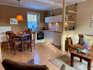 a kitchen and living room with a table and chairs at Ferienwohnung an der Schlei in Fleckeby