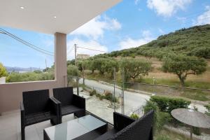 a balcony with chairs and a view of a road at Villa Dionysia Studio 9 in Alikanas