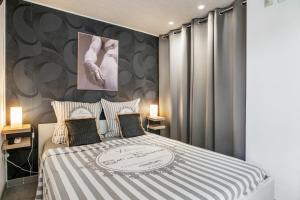 a bedroom with a bed with gray curtains at Villa Nui in Cuers