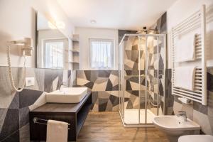 a bathroom with a sink and a shower at Apartment Sis Residence Bun Ste in San Vigilio Di Marebbe +31 photos