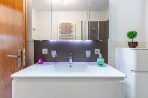 a bathroom with a white sink and a mirror at Triberg Blick in Triberg +18 photos