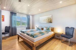 a bedroom with a large bed and two chairs at Triberg Blick in Triberg