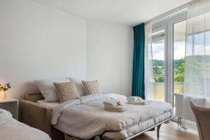 a bedroom with a bed and a large window at Ferienwohnung Mainaublick in Uhldingen-Mühlhofen +31 photos