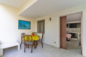 a kitchen and dining room with a table and chairs at La Castellana in Gallipoli