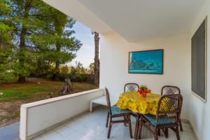 a porch with a table and chairs on a balcony at La Castellana in Gallipoli