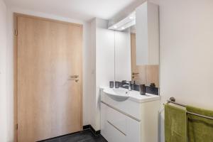 a bathroom with a sink and a mirror at Das Schwarzwälder Speckhuisli in Grafenhausen +76 photos