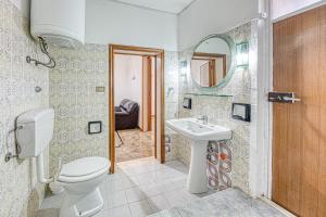 a bathroom with a toilet and a sink and a mirror at Cod 278 al centro del paese in Ugento +12 photos