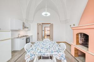 a dining room with a table and a fireplace at Cod 278 al centro del paese in Ugento
