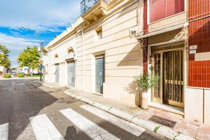 a building with a potted plant on the side of a street at Cod 278 al centro del paese in Ugento