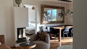 a living room with a chair and a dining room at Traumhaus mit herrlichem Graz Blick in Graz +29 photos