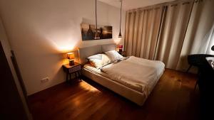 a bedroom with a bed and a table with a lamp at Traumhaus mit herrlichem Graz Blick in Graz