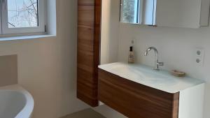 a bathroom with a sink and a toilet at Traumhaus mit herrlichem Graz Blick in Graz
