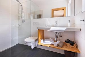 a bathroom with a sink and a toilet and a shower at Niedermaierhof in Kastelbell-Tschars +64 photos