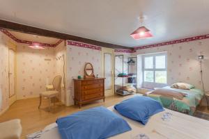 a bedroom with two beds and a dresser at O’bord Du Gave in Saucède