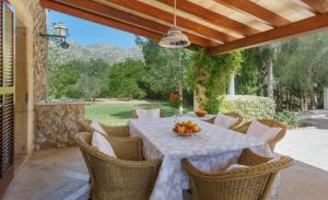 a table with a bowl of fruit on a patio at Llangana in Pollença