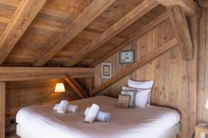 a bedroom with a bed in a wooden attic at Mazot de Warens in Combloux