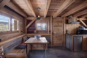 a kitchen in a log cabin with a table at Mazot de Warens in Combloux +3 photos