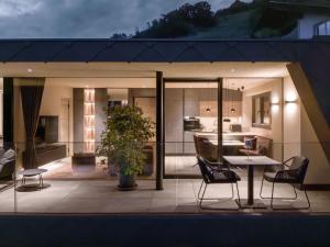 a house with a balcony with a table and chairs at Levita Living Freiheit in Tirolo