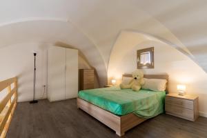 a teddy bear sitting on a bed in a bedroom at Casa Incanto in Presicce