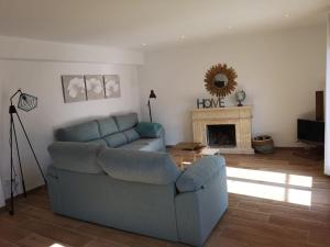 a living room with a couch and a fireplace at Villa Arbona Dalt in Sóller