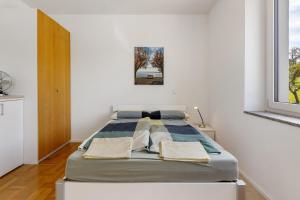 a bedroom with a bed in a white room at Studio im Grünen und Bodenseenähe in Rielasingen-Worblingen