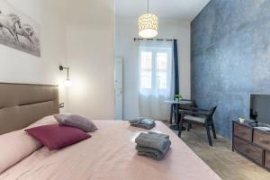 a bedroom with a large bed and a television at Casa Luna in Pozzallo