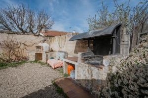 a stone oven in a yard next to a building at La Alameda in Marazuela