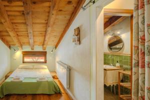 a small bedroom with a bed and a bathroom at La Alameda in Marazuela +27 photos