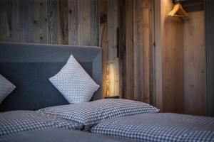 a bedroom with a bed with a pillow on it at Rueper Hof Chalet Dolomit in Valdaora