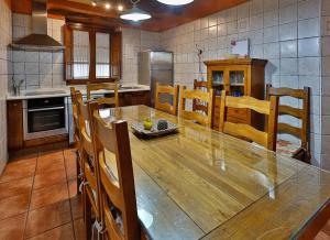 a kitchen with a large wooden table and chairs at El Lagar in Canalejas de Peñafiel