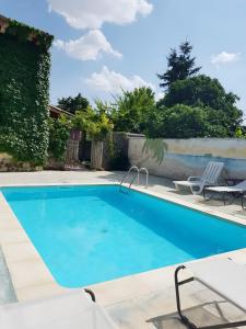 a large swimming pool with a chair at La Alameda in Marazuela