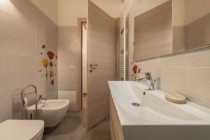a bathroom with a sink and a tub and a toilet at Nonno Bigi Tulipano in Tremosine Sul Garda +22 photos