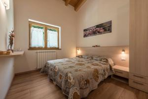 a bedroom with a large bed in a room at Nonno Bigi Tulipano in Tremosine Sul Garda