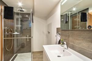 a bathroom with a sink and a shower at Ferienwohnung Helms in Eriskirch +11 photos