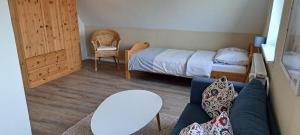 a living room with a bed and a couch at Fewo Sandbank in Pellworm