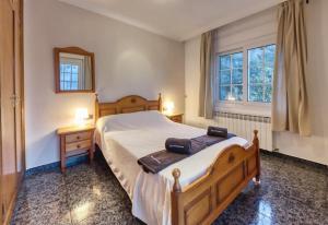 a bedroom with a large bed and a window at Costacabana - Villa Rosa in Lloret de Mar