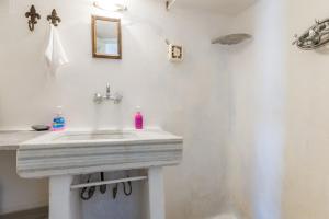 a bathroom with a white sink and a mirror at Haus Nikos - Tinos - Arnados in Arnados +22 photos