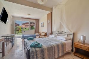 a hotel room with a bed and a table and chairs at Christianna studios in Nikiana