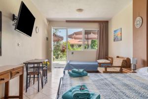 a hotel room with a bed and a living room at Christianna studios in Nikiana