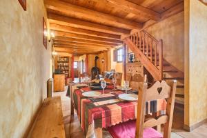 a dining room with a table and a staircase at Chateau De Merande in Arbin