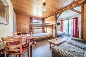 a room with a bunk bed and a table at Gand chalet montagne 30 personnes in Bernex +31 photos