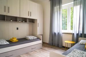 a bedroom with two beds and a window at appartamento casa stefi n2 in Malcesine +30 photos