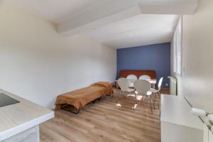 a kitchen and dining room with a table and chairs at Logis Les Forges in Arvillard