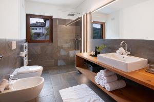 a bathroom with a sink and a toilet at Ansitz Röfen in Burgusio +104 photos