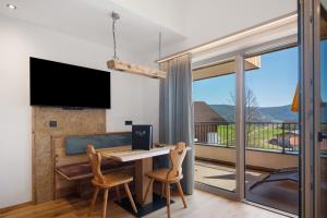 a home office with a desk and a balcony at Moarhof in Meltina