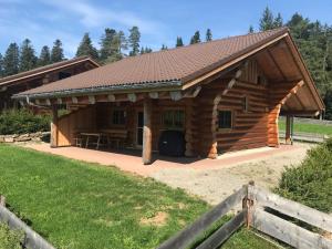 a large log cabin with a roof at Blockhaus Almhütte Wiesenglück in Glatten +14 photos